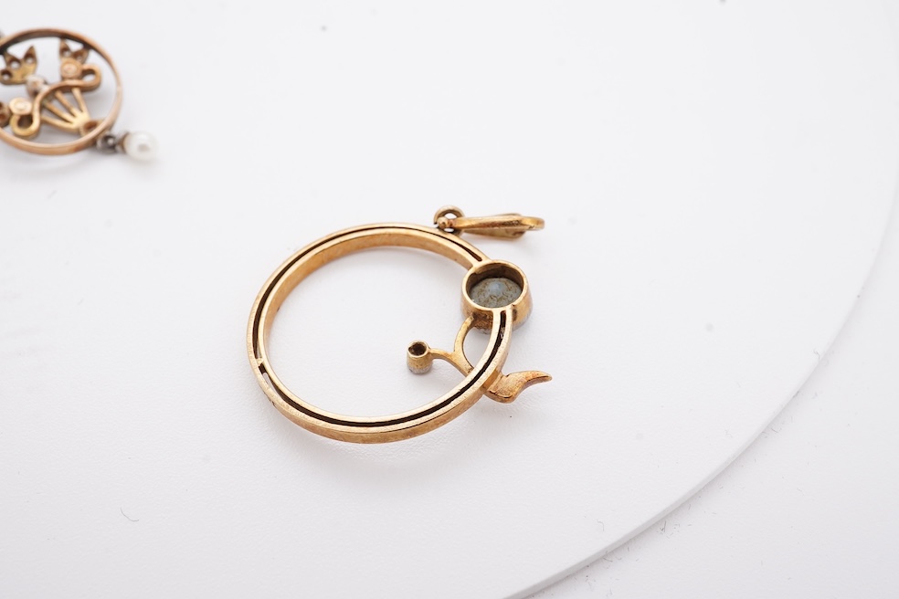 An early 20th century yellow metal, diamond chip and seed pearl set drop pendant, overall 23mm, together with a similar yellow metal, diamond and gem set open work pendant, diameter 20mm, gross weight 3.7 grams. Conditio